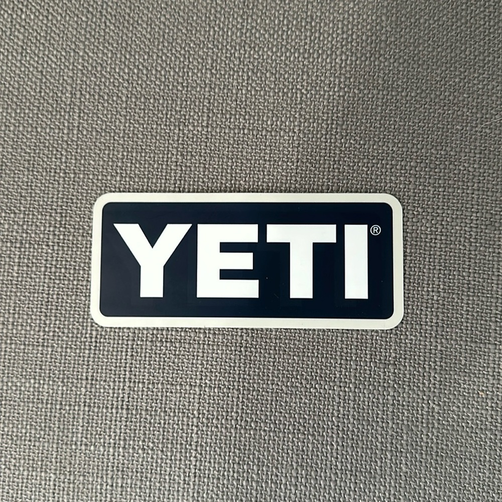 Yeti sticker. Gray trim with dark blue background and white writing. Soft edges